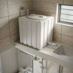 100 Litre Loft Water Tank installed on elevated platform in a bathroom utility space with plumbing connections
